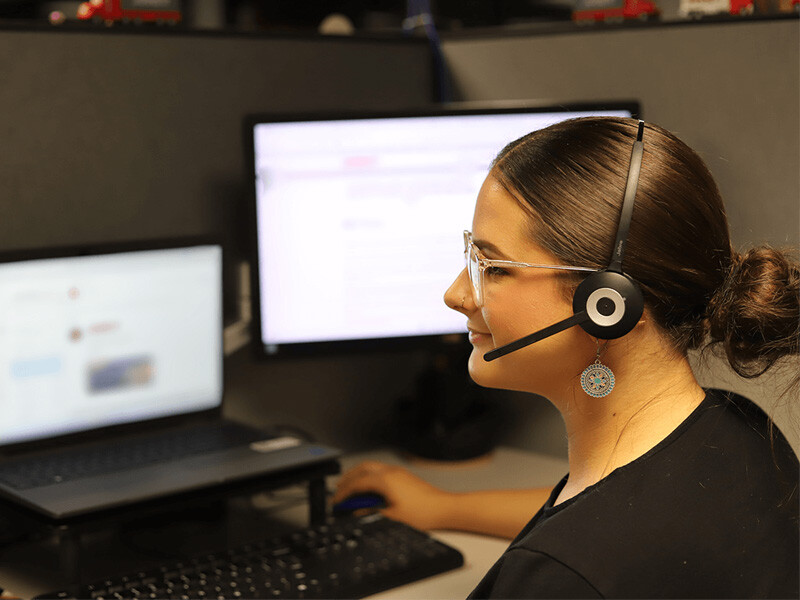 Young woman looking at managed transportation computer screens