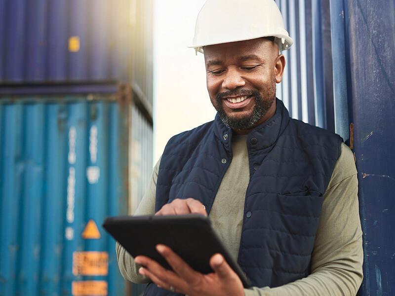 Shipyard worker working on tablet