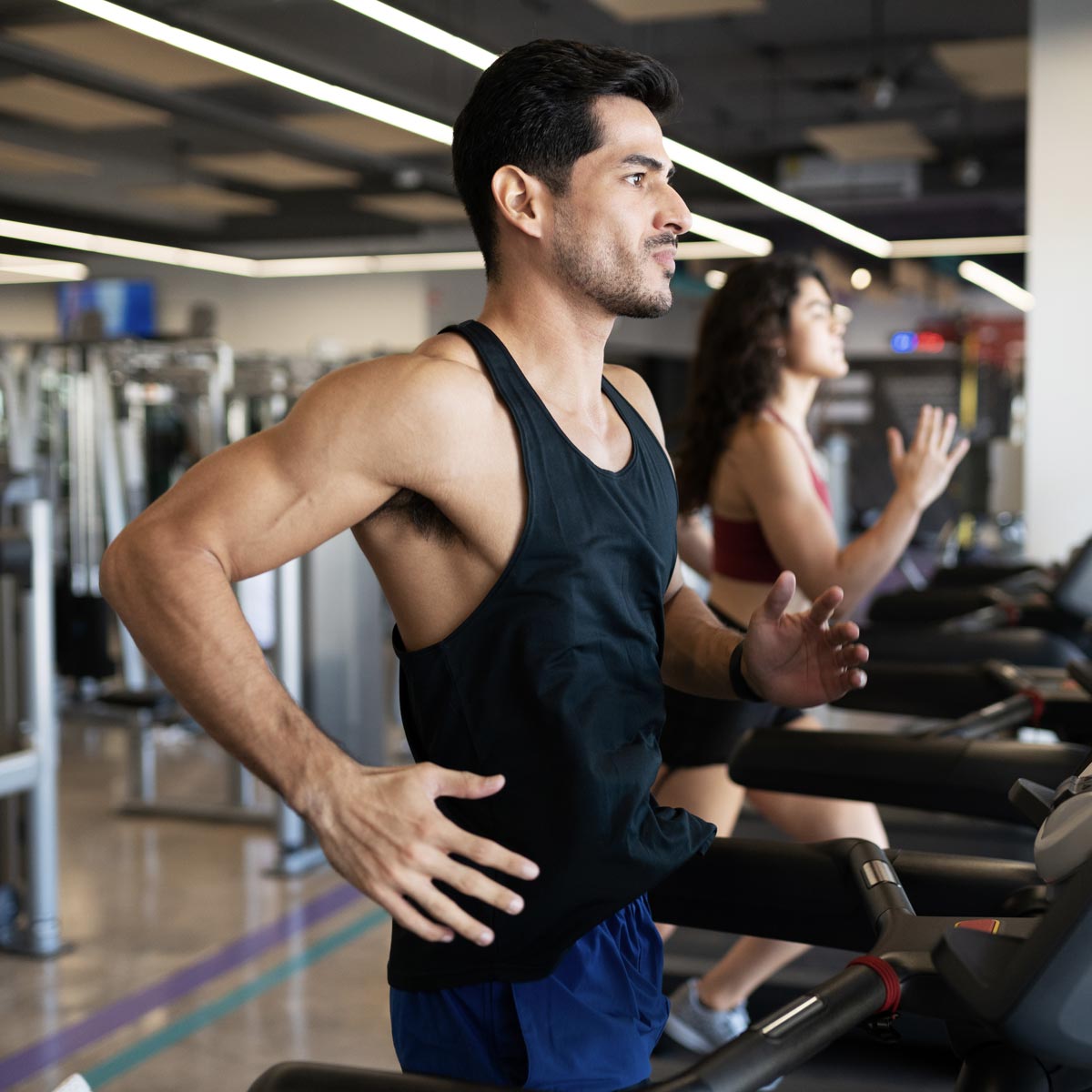 Focused man running on treadmill