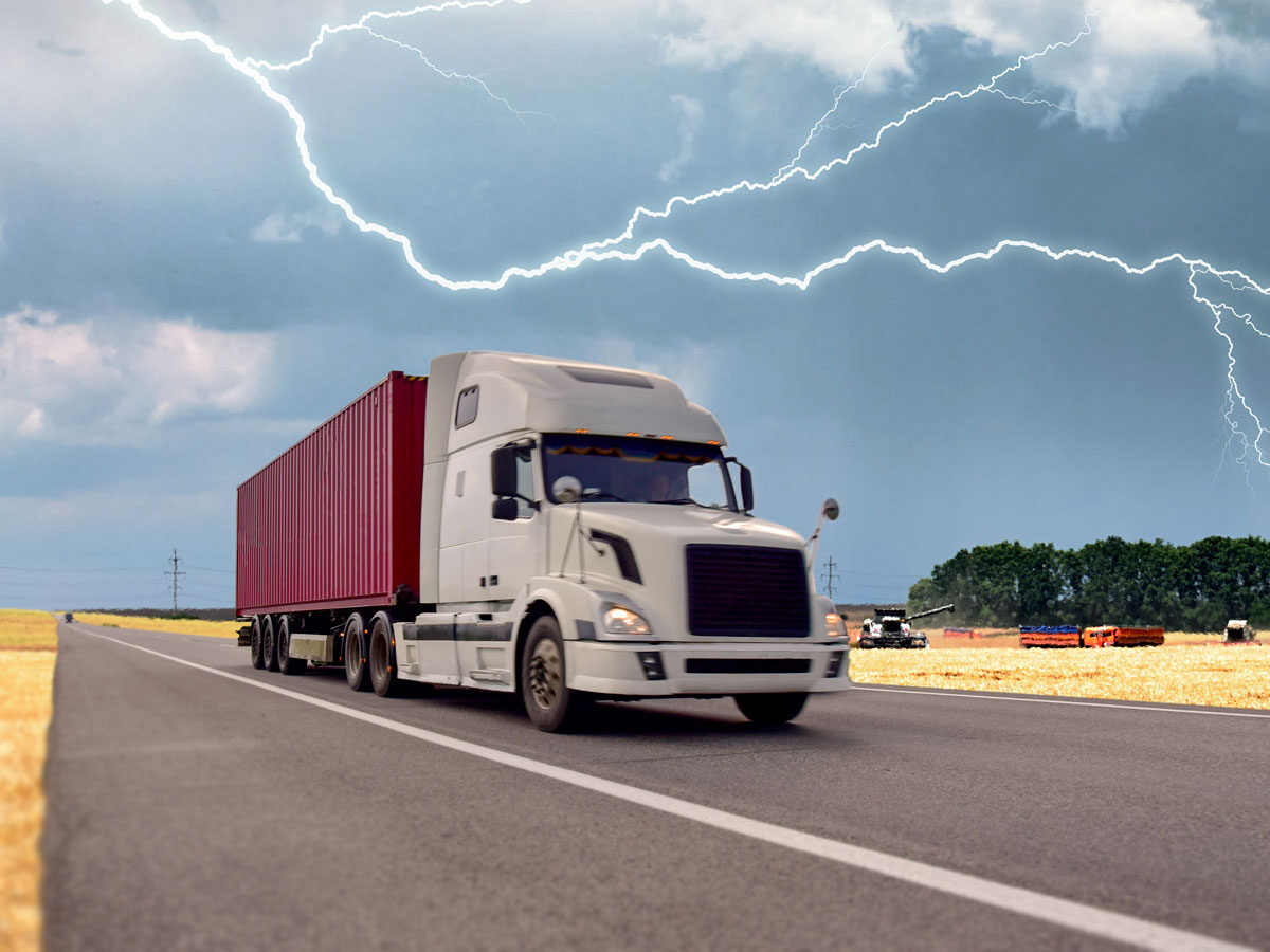 Semi truck driving midwest experiencing summer storm weather conditions