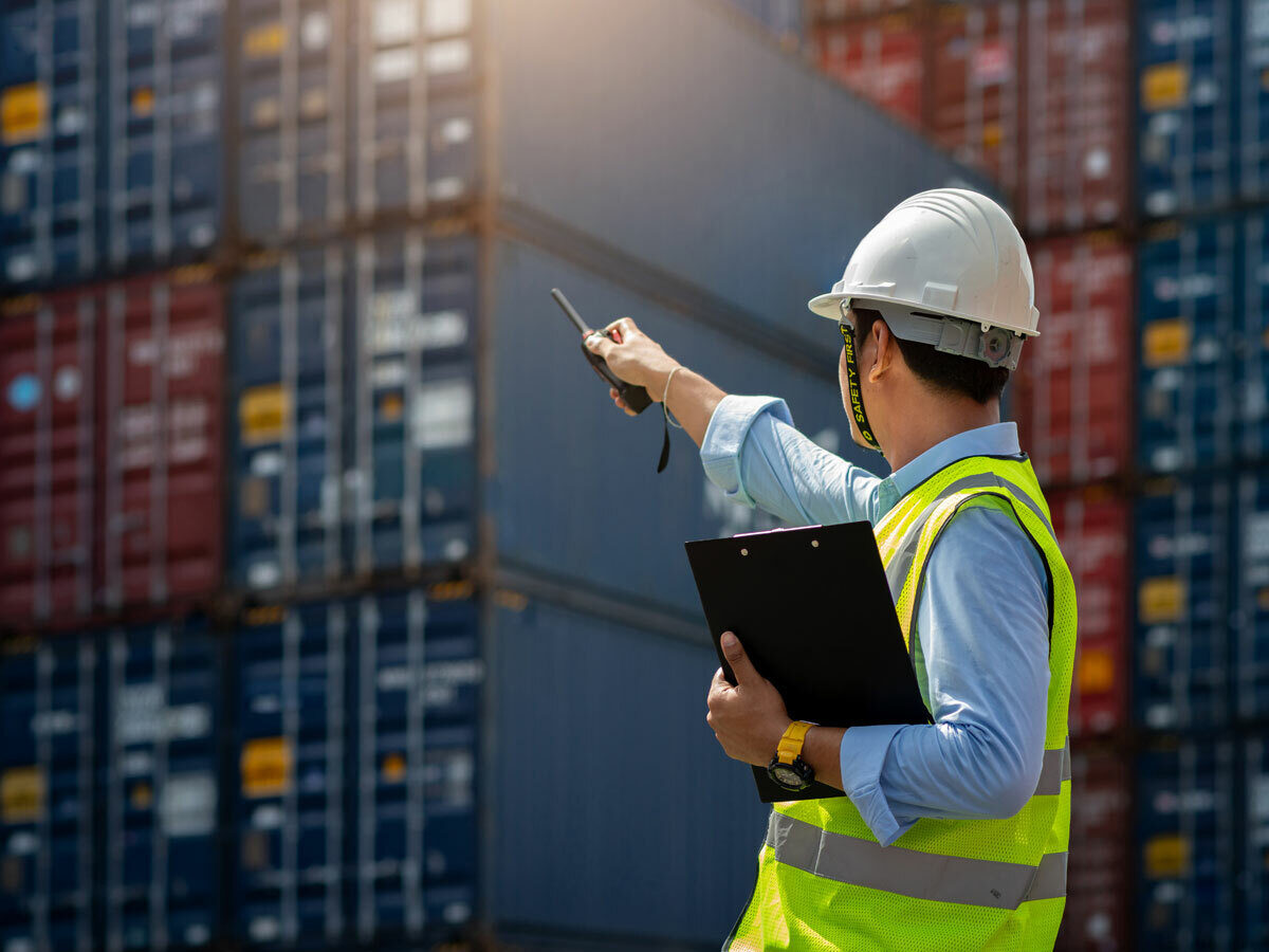 Cargo worker inspecting containers on an international ship